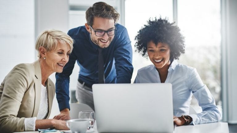 Business team reviewing online reputation management tools on laptop.